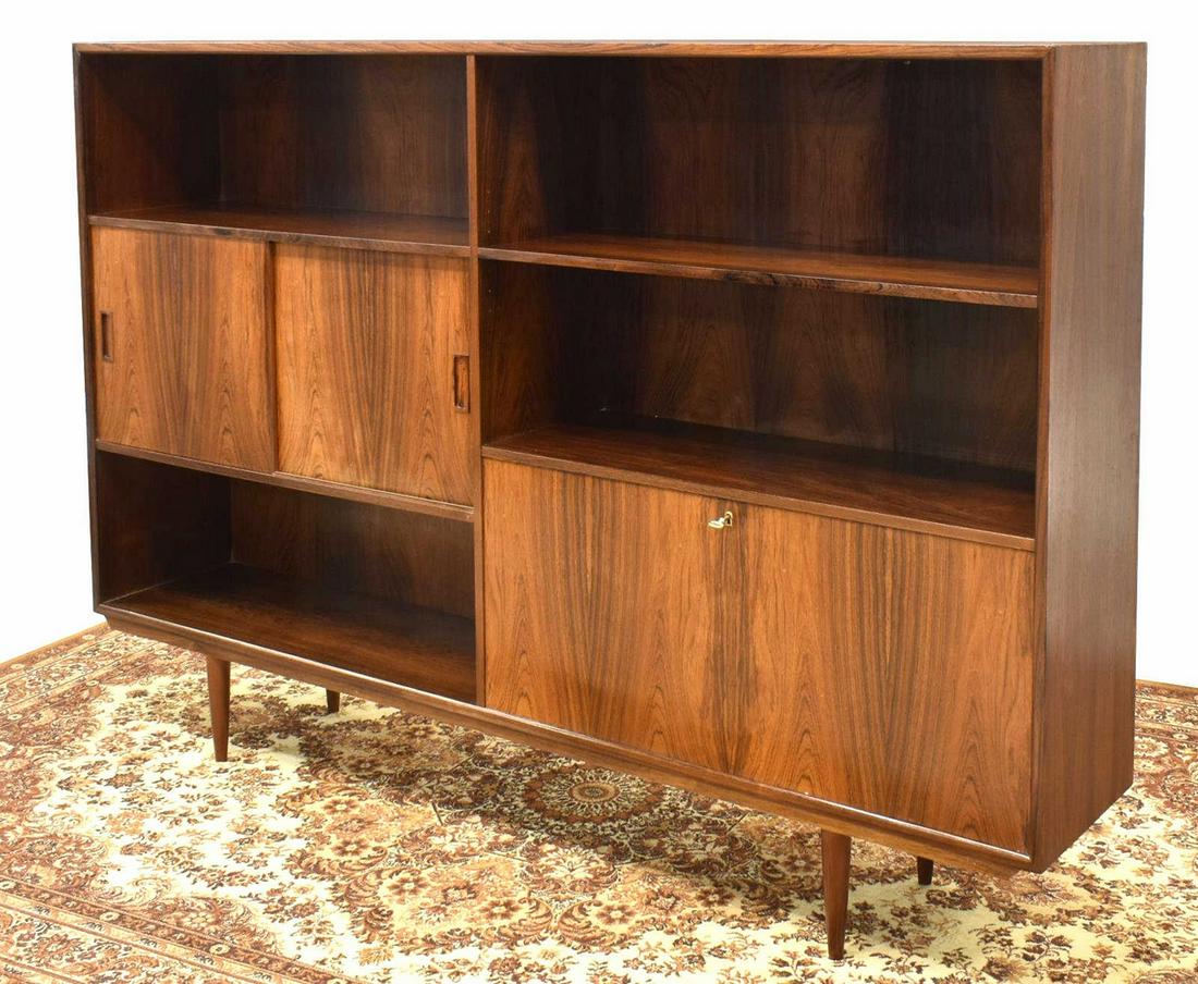 DANISH MID-CENTURY MODERN ROSEWOOD SIDEBOARD: Danish mid-century modern rosewood sideboard/ bookcase, c.1960s, having open display shelves, dual sliding doors revealing interior shelves, lower drop-front door opening to felt-lined drawers and bar