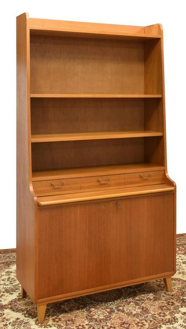 DANISH MID-CENTURY MODERN TEAK BOOKCASE SIDEBOARD: Danish mid-century modern teakwood sideboard, c.1950s, fitted with adjustable shelves, over three drawers and pull-out surface, lower cabinet opens to interior with shelves and drawers, rising on shor