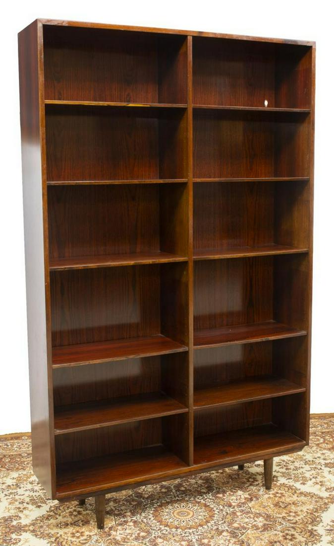 DANISH MID-CENTURY OMANN JUN ROSEWOOD BOOKCASE: Danish mid-century modern rosewood bookcase, manufactured by Omann Jun A/S, Model Nr. 12, c.1960s, having adjustable height shelves, rising on tapered legs, approx 76.75"h, 47.5"w, 11.5"d Start Price: