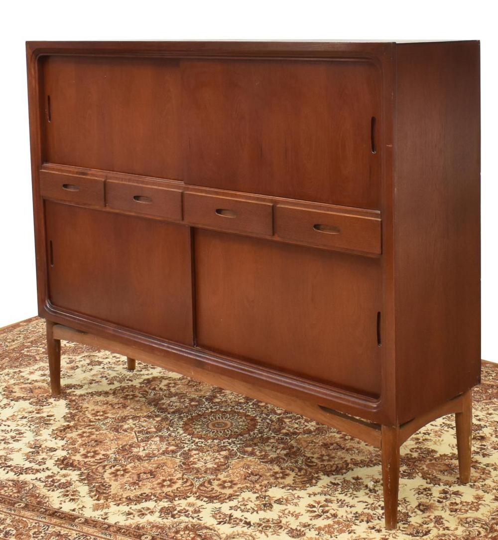 DANISH MID-CENTURY MODERN TEAK SIDEBOARD: Danish mid-century modern teak sideboard, c.1950s, rectangular case, fitted with four central drawers, flanked by upper and lower sliding doors, opening to interior shelves, on tapered legs, approx 52