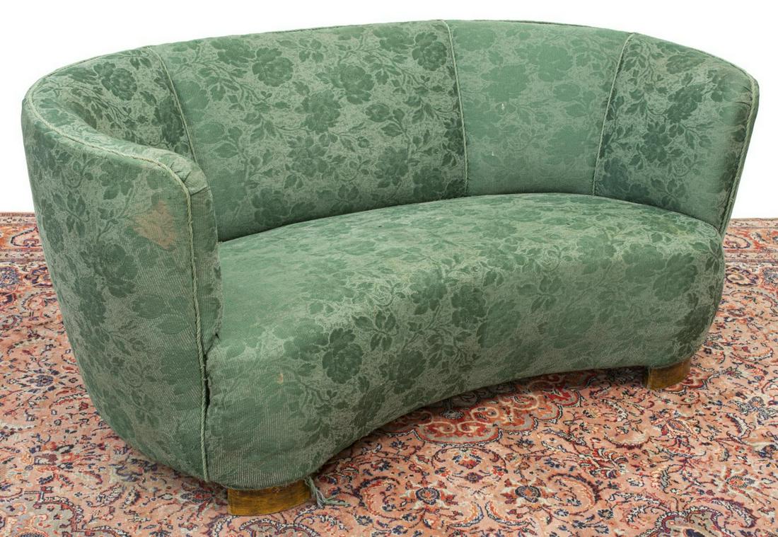 DANISH MODERN UPHOLSTERED SHELL-BACK SOFA: Danish modern banana form sofa, c.1940s, in floral green upholstery, on short wood supports, wear and pulling to cord trim near base, approx 25.25"h, 62"w, 33"d Start Price: $200.00