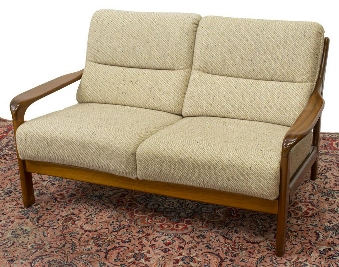 DANISH MID-CENTURY MODERN 2-SEAT TEAK FRAME SOFA: Danish mid-century modern two-seater loveseat/ sofa, c.1950s, having teak frame, with ladder back, tan upholstered removable back and seat cushions, approx 30"h, 51.5"w, 32"d Start Price: $200.00