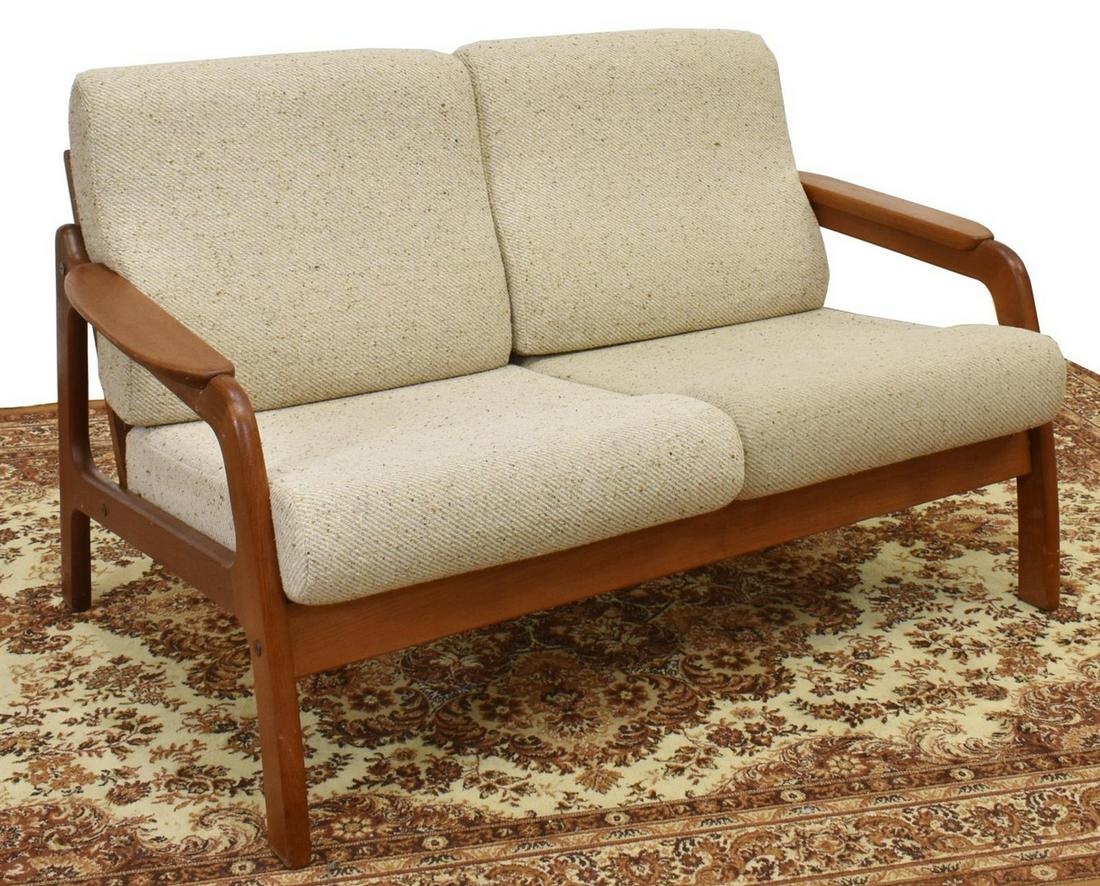 DANISH MID-CENTURY MODERN 2-SEAT TEAK FRAME SOFA: Danish mid-century modern two-seater loveseat/ sofa, c.1960s-1970s, having teak frame, with ladder back, tan upholstered removable back and seat cushions, approx 32"h, 54"w, 33"d Start Price: $200.00