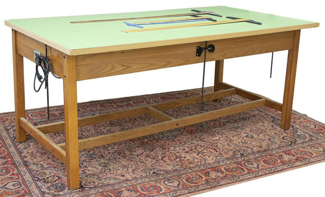 WORK BENCH TABLE WITH ELECTRICAL OUTLET: Work table, late 20th c., laminate top, oak frame, with power outlet, approx 37"h, 84"w, 44.5"d Start Price: $100.00