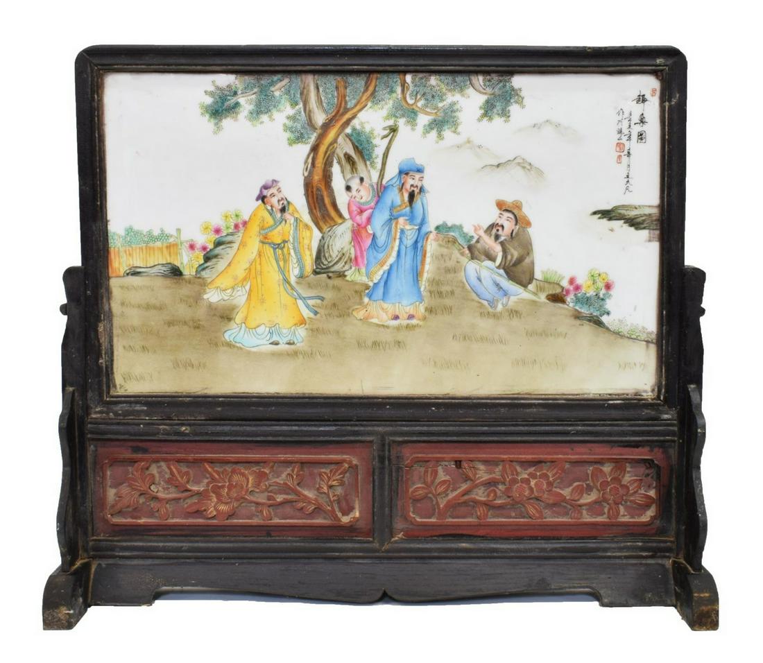FRAMED CHINESE FAMILLE ROSE PORCELAIN TABLE SCREEN: Framed Chinese Famille Rose porcelain table screen, white ground with painted immortal figures on hill top, with foliate, floral design, encased in hardwood stand, approx sight: 12"h, 21"w, overall: 2