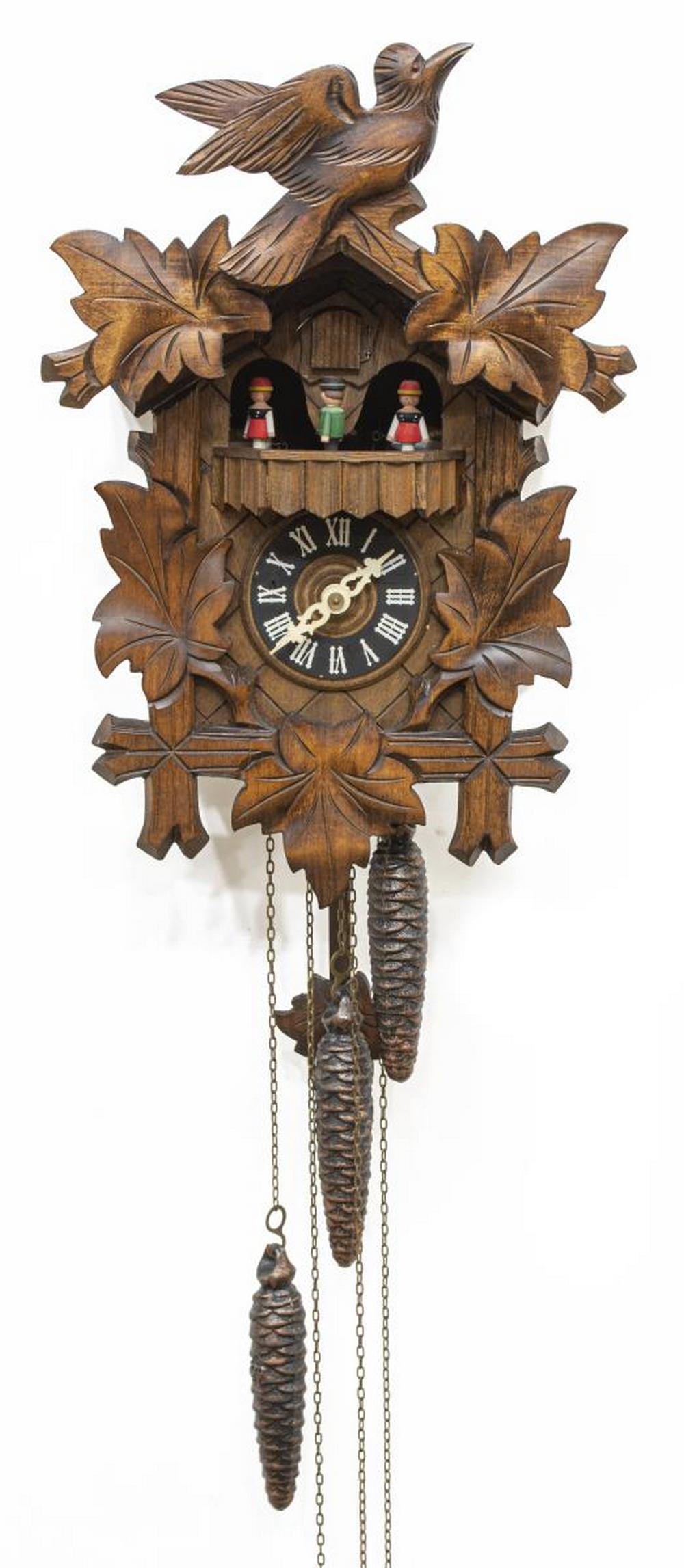 VINTAGE GERMAN REGULA MUSICAL CUCKOO CLOCK: Vintage German carved cuckoo clock, mid 20th c., Regula, featuring bird and foliate crest, rotating disc with four figures, black dial with white roman numerals, triple weight driven Swiss Musical mov