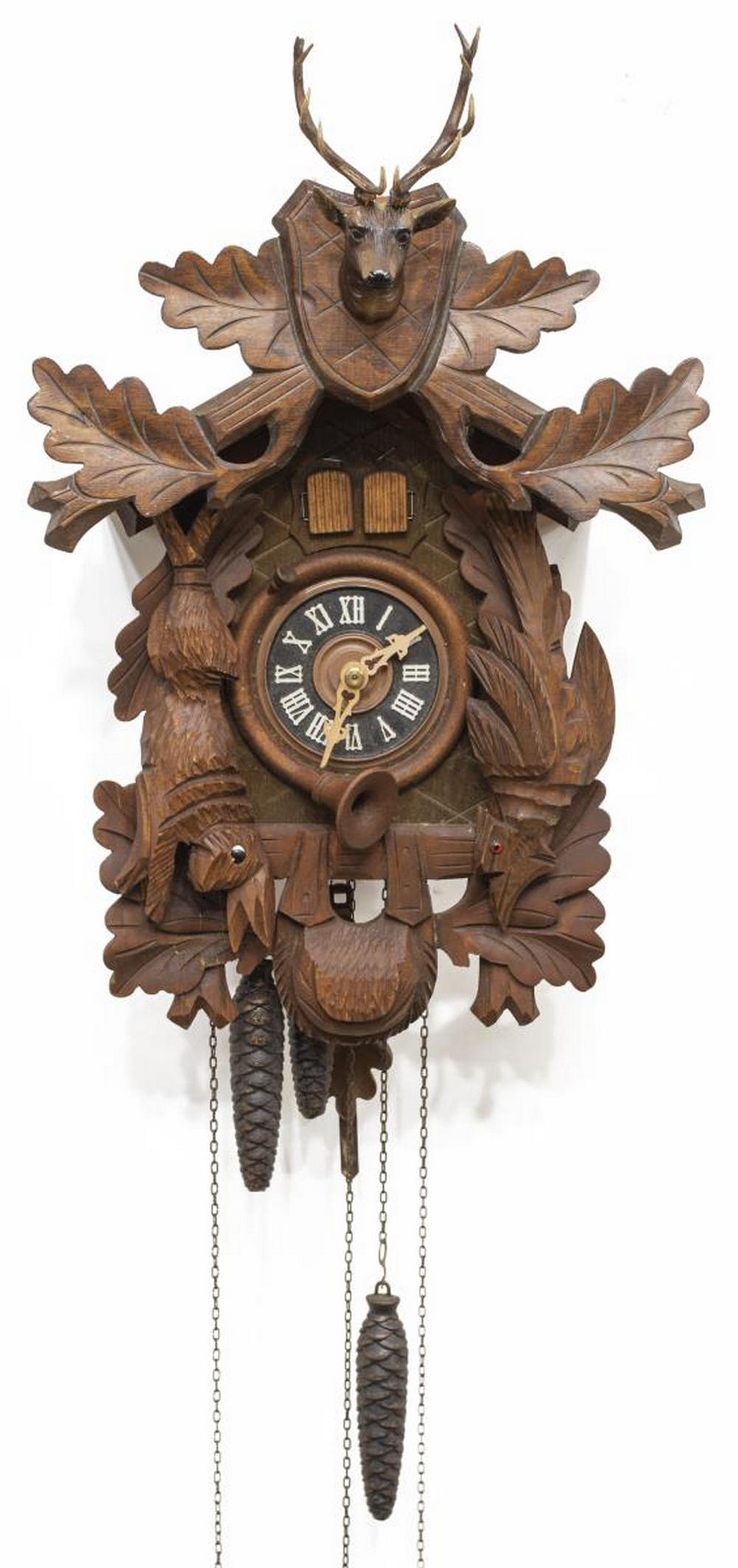 VINTAGE GERMAN REGULA MUSICAL CUCKOO CLOCK: Vintage German carved cuckoo clock, mid 20th c., Regula, featuring stag head and oak branch crest, black dial with white roman numerals, hunting motif with bird and rabbit, triple weight driven Swiss 