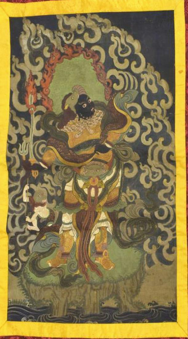 TIBETAN THANGKA CANVAS & SILK TAPESTRY: Tibetan Thangka tapestry, painted on canvas, depicting central Buddhist deity and surrounding figures, matted on embroidered silk, approx 43.5"l, 32"w Start Price: $80.00