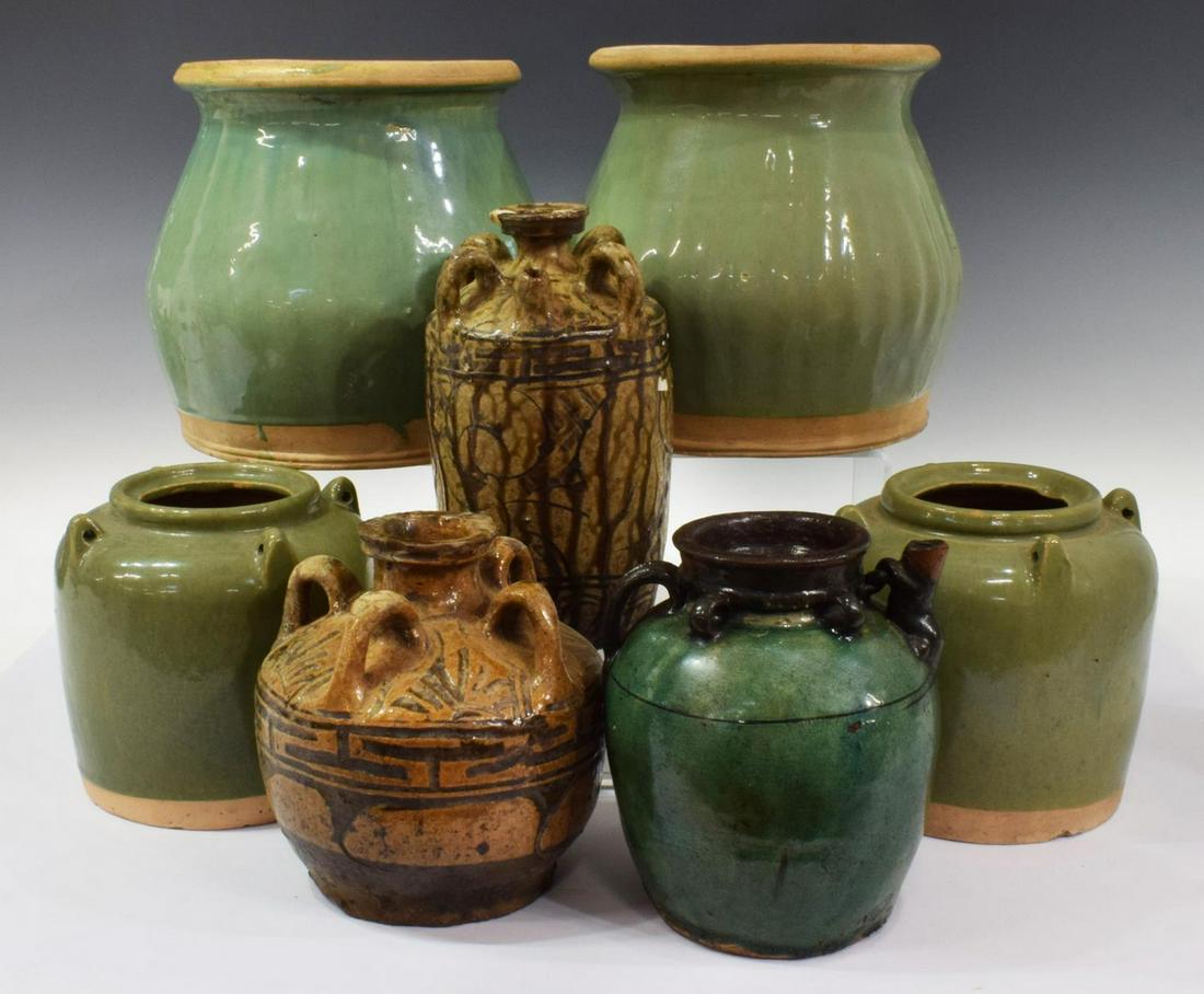 (7) CHINESE GLAZED EARTHENWARE OIL JARS & PLANTERS: (lot of 7) Chinese earthenware oil jars and planters, comprising: (6) oil jars, of varied size and similar form, (two) glazed brown with running ornamentation, (one) glazed green with dark brown trim,