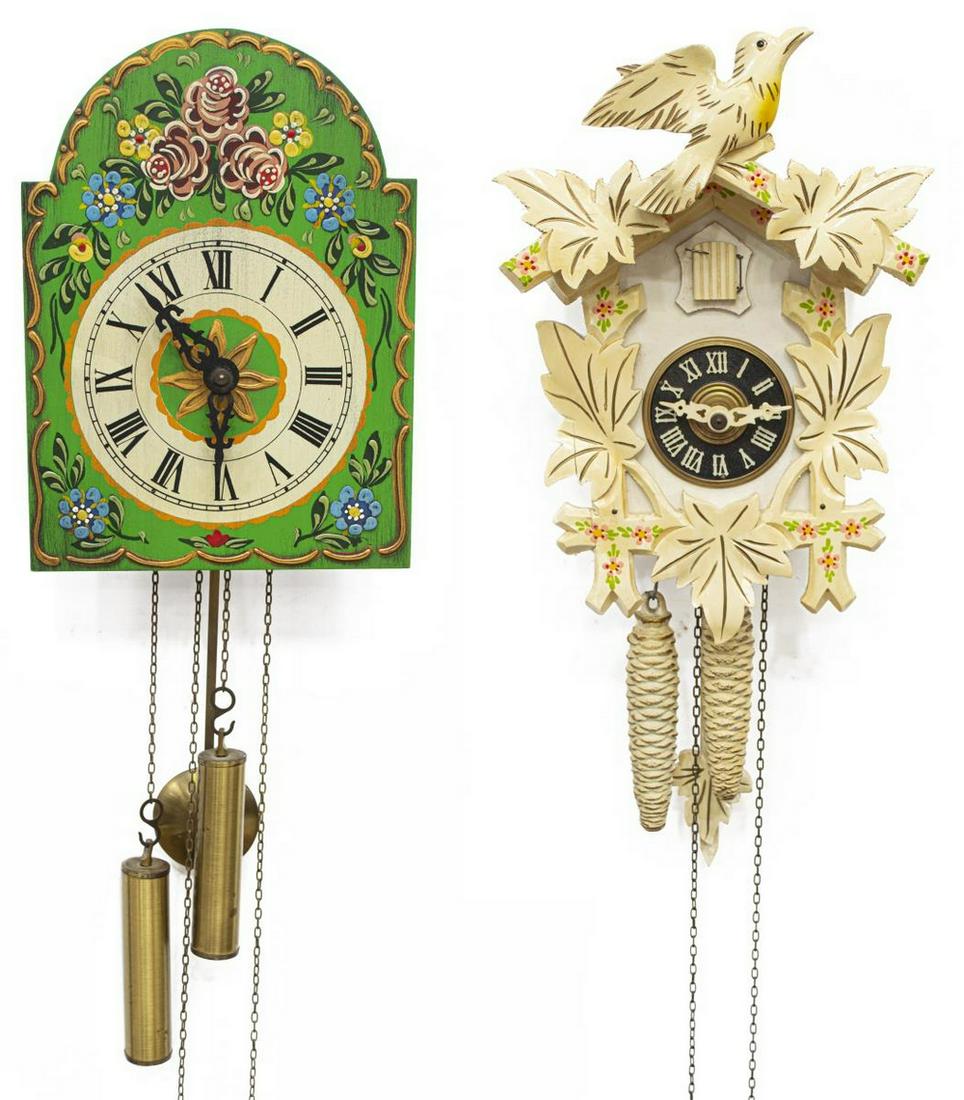 (2) GERMAN POLYCHROME PAINTED CUCKOO CLOCKS: (lot of 2) German painted wood cuckoo clocks, comprising: (1) having polychrome flowers on green ground, black Roman numerals to white clock face, centering gilt sunburst, retaining weights and pendul