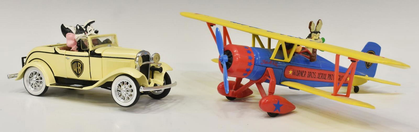 (2) ERTL COLLECTIBLES, WARNER BROS. LOONEY TUNES: (lot of 2) Ertl Collectibles, Warner Brothers Looney Tunes sculptures, both in original boxes, accompanied with certificates of authenticity, including: (1) Wile E. Coyete and the Road Runner, 1931 St