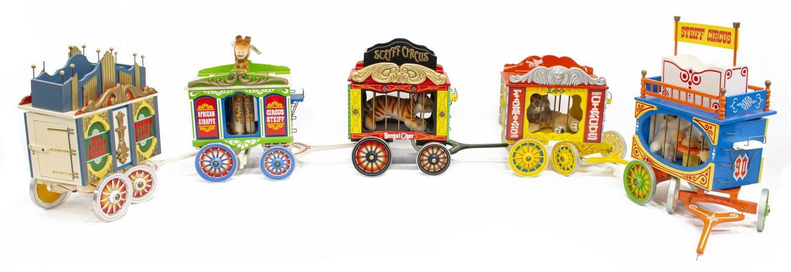 5) STEIFF GOLDEN AGE OF THE CIRCUS TRAIN & ANIMALS: (lot of 5) German Steiff Circus Train, made up of painted wood carts on wheels, each housing varied circus animal toys, approx 12"h, 85"w, 6"d; 18.5lbs total Start Price: $100.00
