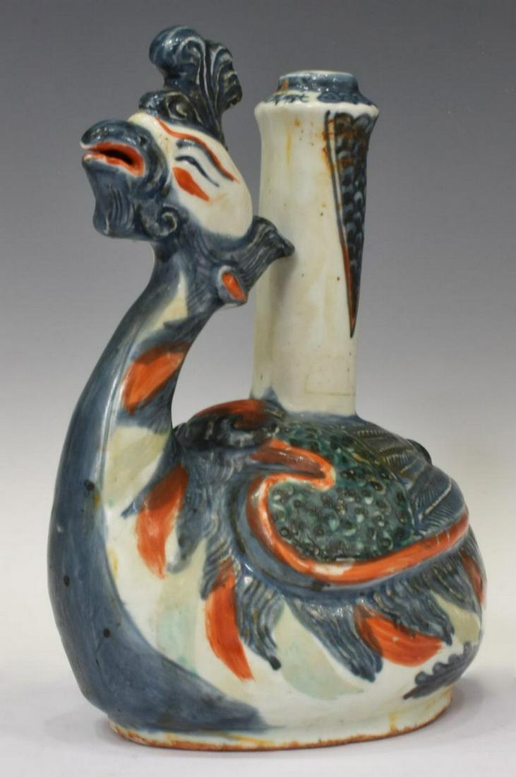 CHINESE PORCELAIN PHOENIX-FORM KENDI VESSEL: Chinese Ming Dynasty style porcelain Kendi vessel in the form of a phoenix, with blue and iron red glazes, characters around upper rim, approx 8.25"h, 6.5"w, 4.25"d, 2.25lbs Start Price: $80.00