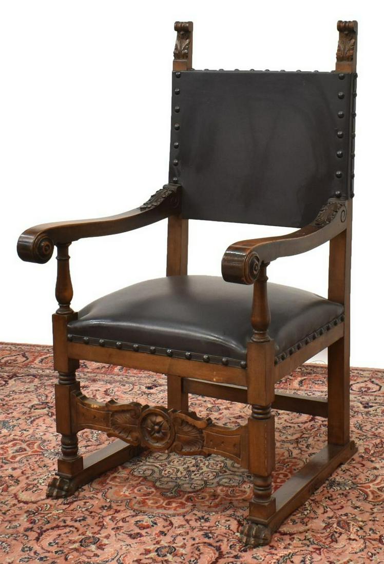 ITALIAN RENAISSANCE REVIVAL WALNUT ARMCHAIR: Italian Renaissance Revival walnut armchair, early 20th c., having foliate carved finials, over leather upholstered back and seat, with nail head borders, scrolled handholds, foliate carved crest on f