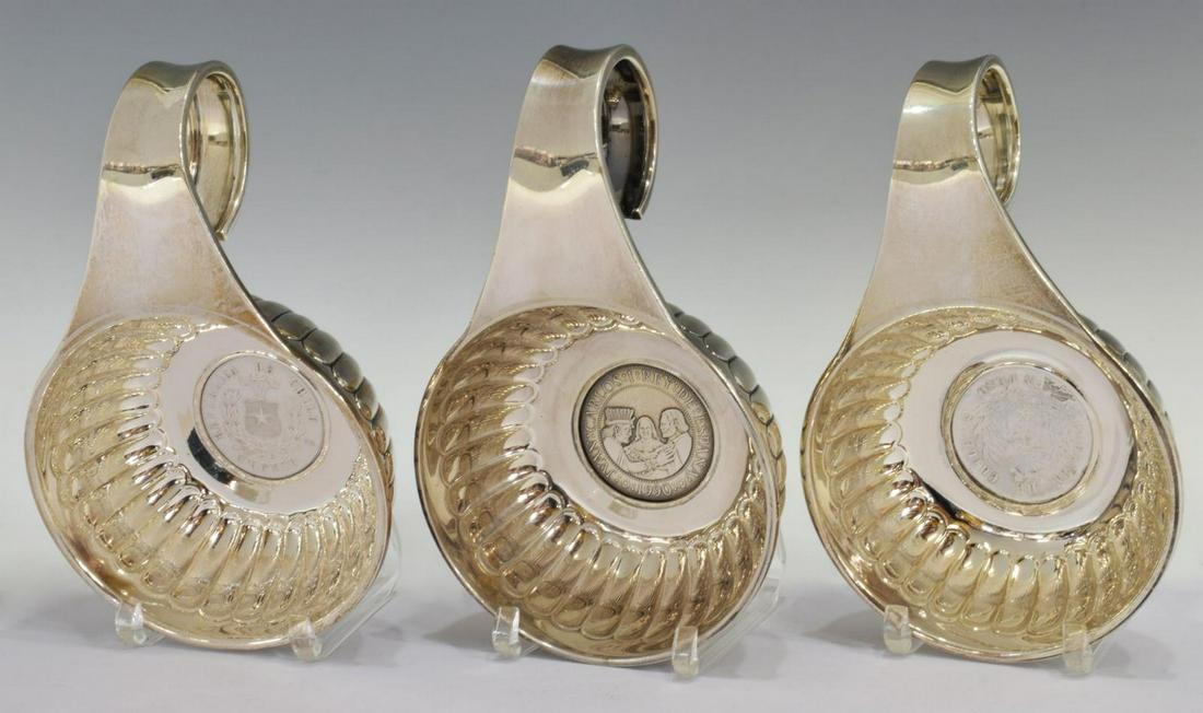 3) VILLA MEX STERLING HANDLED BOWLS W/ INSET COINS: (lot of 3) Sterling silver handled bowls, Villa, Mexico, 20th c., in the form of a wine tasting cup (tastevin), fluted bowl with inset coin, single scrolled handle, including: (2) Republica de Chile U