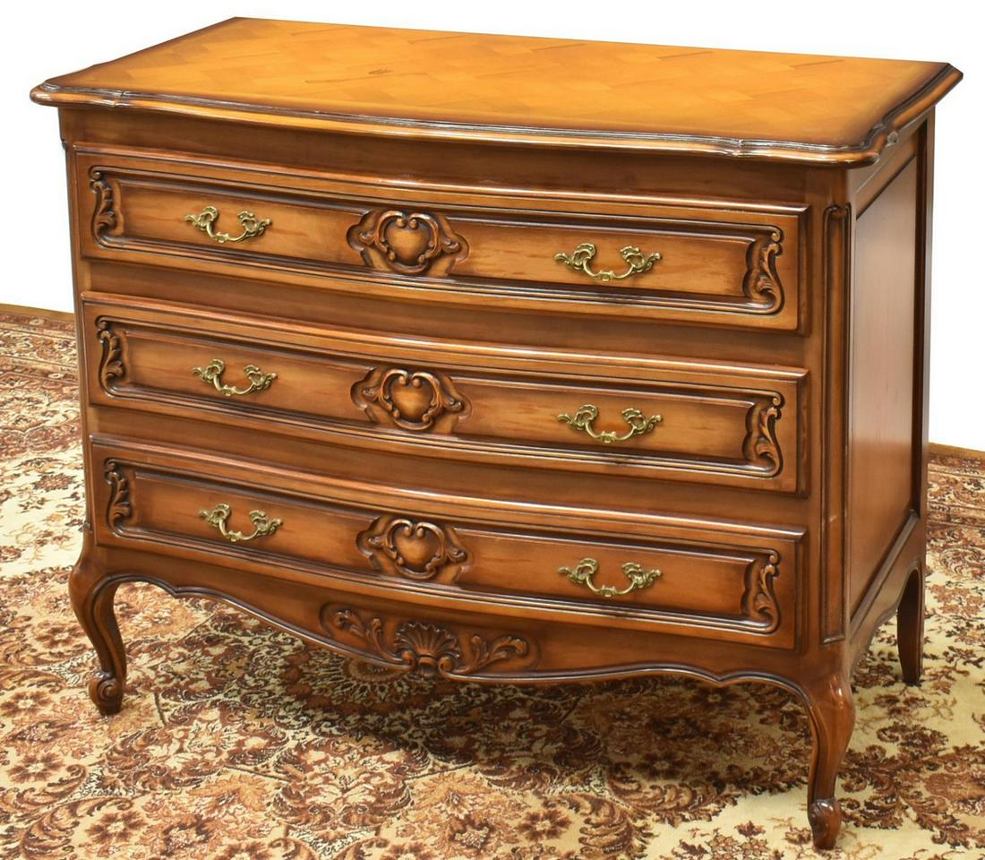 FRENCH LOUIS XV STYLE FRUITWOOD COMMODE: French Louis XV style fruitwood commode, 20th c., shaped top, over case fitted with three drawers, carved foliate motifs, rising on cabriole legs, ending in whorl feet, approx 32.5"h, 41.25"w, 20"d St