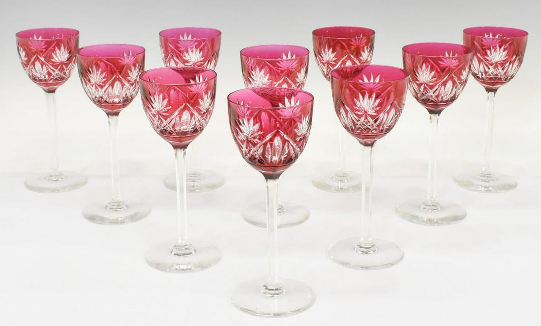 (10) BOHEMIAN CRANBERRY CUT TO CLEAR STEMWARE: (lot of 10) Bohemian cranberry cut to clear crystal wine glasses, 20th c., cut hobstar pattern, (one) with ground rim, (one) with small chip to rim, approx 7.5"h, 3"diam; 5.5lbs total Start Price: $40