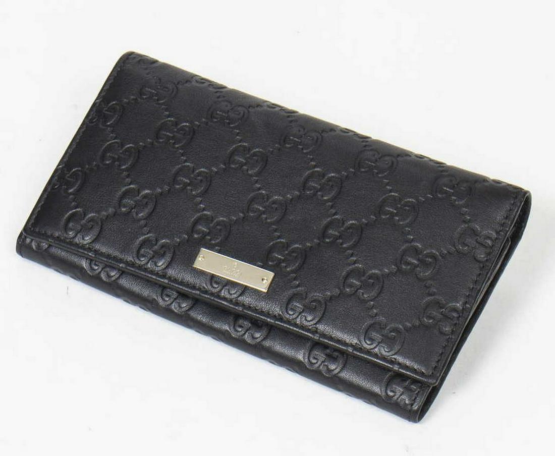 GUCCI BLACK GUCCISSIMA LEAETHER CONTINENTAL WALLET: Gucci continental wallet, in black Guccissima leather, with gold-tone hardware, tonal leather lining, bill compartments, five card slots, snap closure at front flap, wallet: measurements for shipping