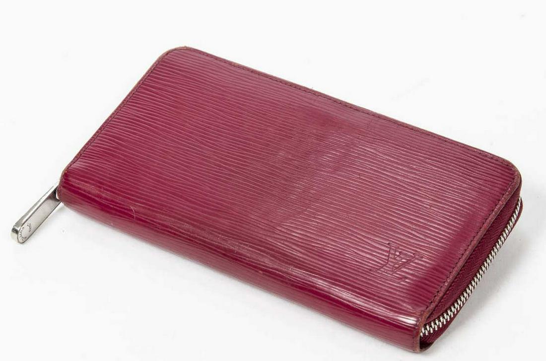 LOUIS VUITTON 'SIPPY' ROUGE POMODORO EPI WALLET: Louis Vuitton "Zippy" wallet, in Rouge Pomodoro Epi leather, with silver-tone hardware, zip around closure opening to tonal leather lined interior, with eight card slots, dual bill compartments and fi