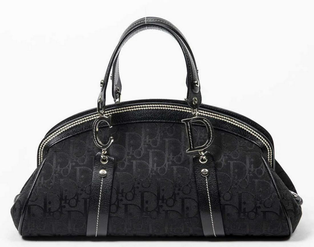 DIOR DIORISSIMO CANVAS LEATHER-TRIMMED BOWLER BAG: Christian Dior bowler bag, in black Diorissimo canvas, with silver-tone hardware, tonal leather trim, with contrasting white stitching, dual flat top handles with CD hardware, zip closure at top, slig