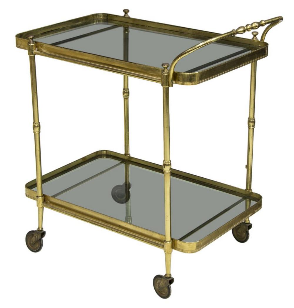 ITALIAN MID-CENTURY BRASS & GLASS SERVICE BAR CART: Italian mid-century modern brass framed service cart, c.1950s, having two smoked glass tiers, rising on castors, some brass discoloration, approx 32"h, 29.5"w, 18.5"d Start Price: $80.00