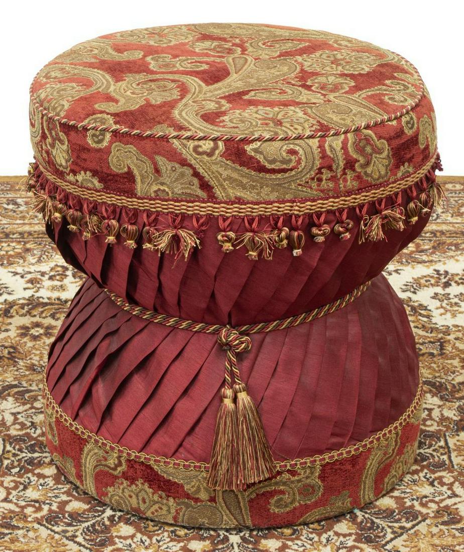 BELLA ROSE UPHOLSTERED OTTOMAN FOOTSTOOL: Upholstered ottoman, Bella Rose, late 20th c., padded seat, over knife pleated hourglass-shaped base, losses to tassel trim, approx 20"h, 19"diam Start Price: $50.00