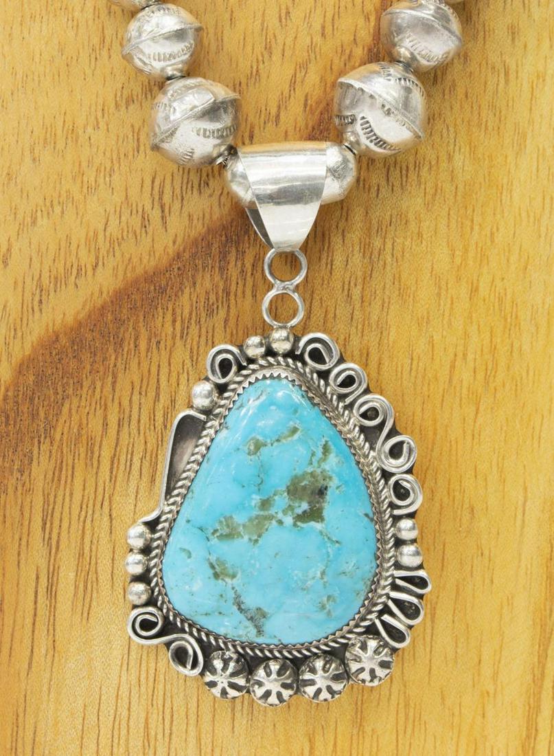 LESLIE NEZ NAVAJO STERLING & TURQUOISE NECKLACE: Native American sterling silver necklace, hallmarked LN (Leslie Nez, Navajo, b.1978), central pendant with large turquoise plaque, on a graduated bench bead strand, approx 20"l, pendant: approx 2.25"h