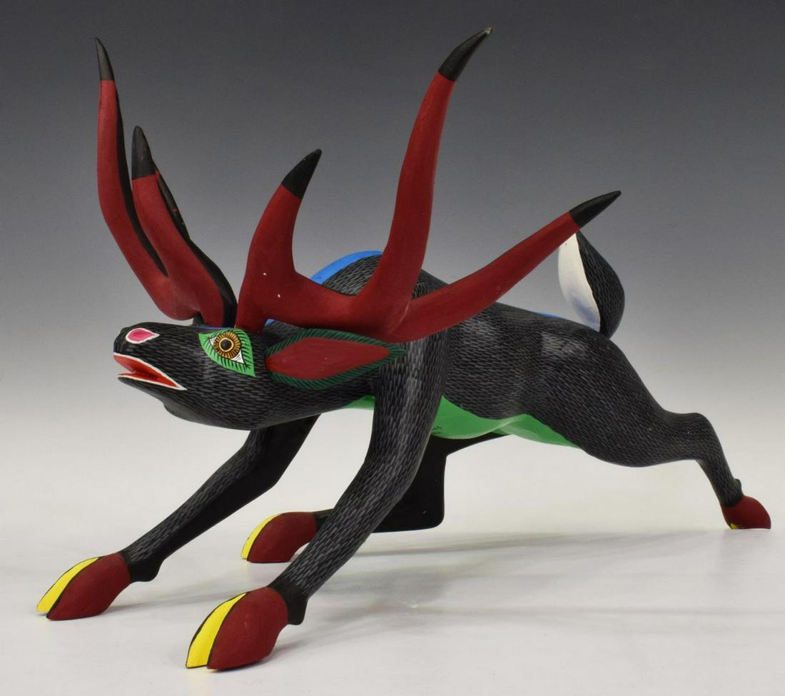 DAMIAN MORALES OAXACA CARVED & PAINTED ALEBRIJE: Folk art alebrije sculpture, Damian Morales, Arrazola, Oaxaca, Mexico, 20th c., carved and polychrome painted wood, modeled as a striding deer, intact with split to back leg, approx 9.25"h, 16.5"l, 5.