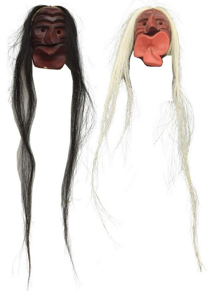 (2) IROQUOIS CARVED WOOD FALSE FACE MASKETTES: (lot of 2) Native American carved wood False Face maskettes, Iroquois, c.1950-1970, including: (1) dark red face, bright red mouth and tongue, approx 7.75"h, 4.5"w, 3"d; (1) dark red/ brown mask, sign