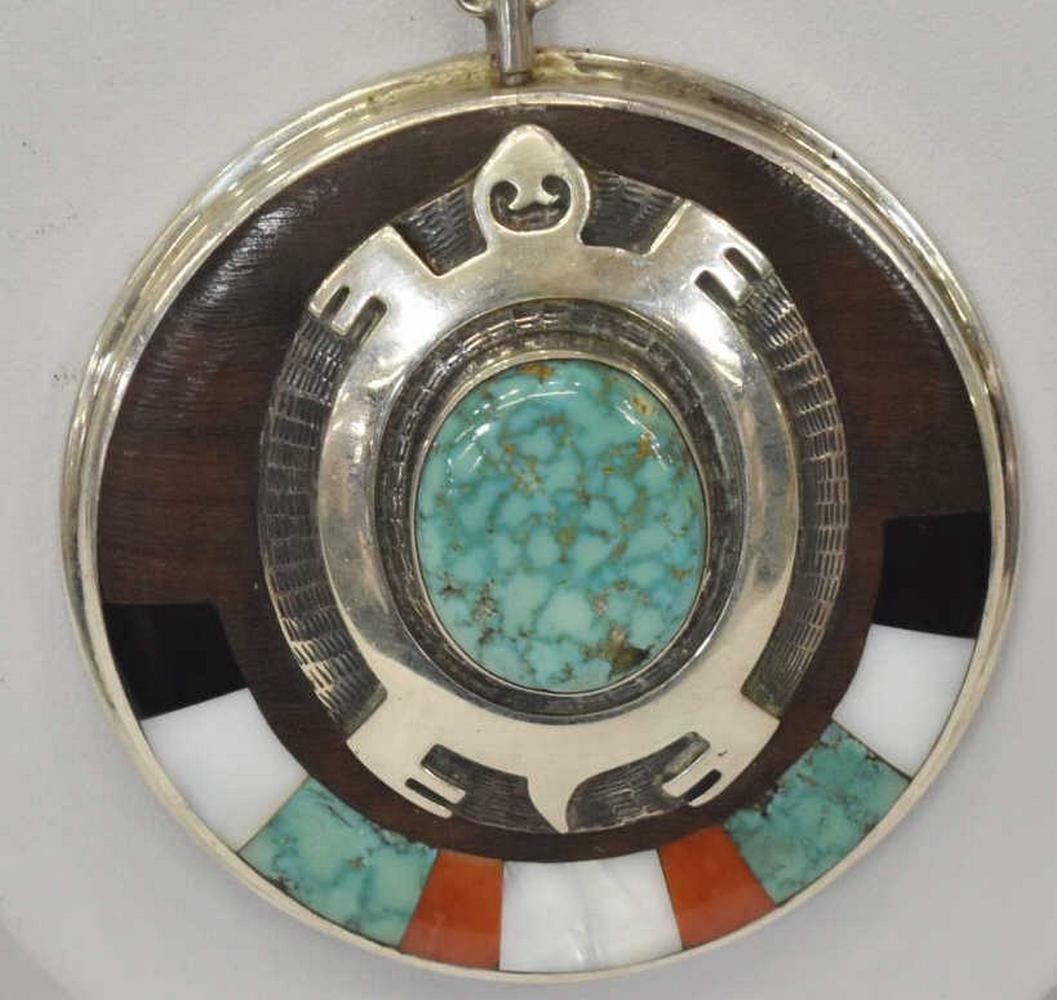 PHILLIP SEKAQUAPTEWA (D.2003) INLAY TURTLE PENDANT: Native American silver (content unknown) turtle pendant necklace, Phillip Sekaquaptewa (Hopi, 1948-2003), large ciruclar pendant inlaid with turquoise, white shell, jet, red coral, and wood, silver ov