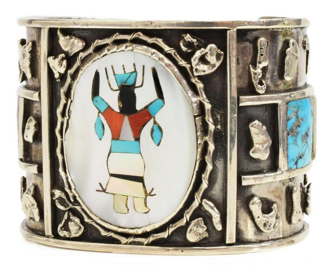 ZUNI SILVER MULTI-STONE INLAY APACHE DANCER CUFF: Native American silver (content unknown) cuff bracelet, likely Zuni, multi-stone inlaid Apache Dancer with turquoise, red coral, jet, abalone, and mother of pearl, approx 2"w, interior: (end to end) a