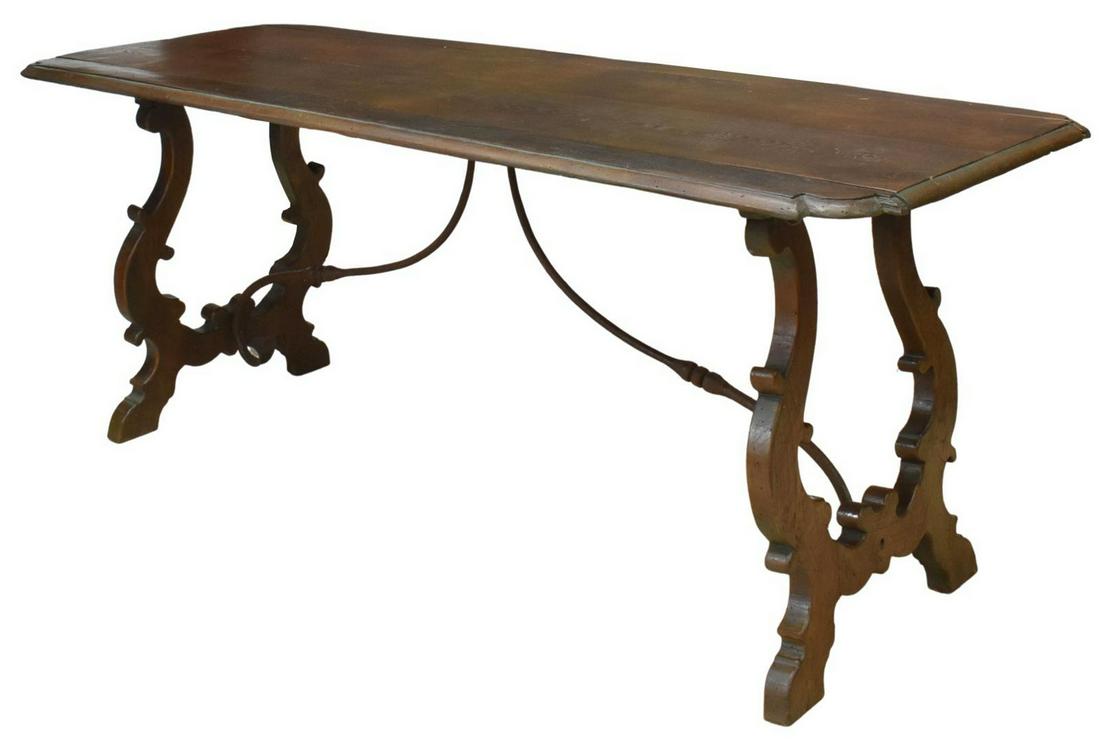 SPANISH BAROQUE STYLE OAK DROP-LEAF TABLE: Spanish Baroque style oak drop-leaf table, early 20th c., having a long double-plank top, over ox yoke supports, joined by curved iron stretchers, approx 31.5"h, 78.5"w, 21.25"d, extended: approx 31"d