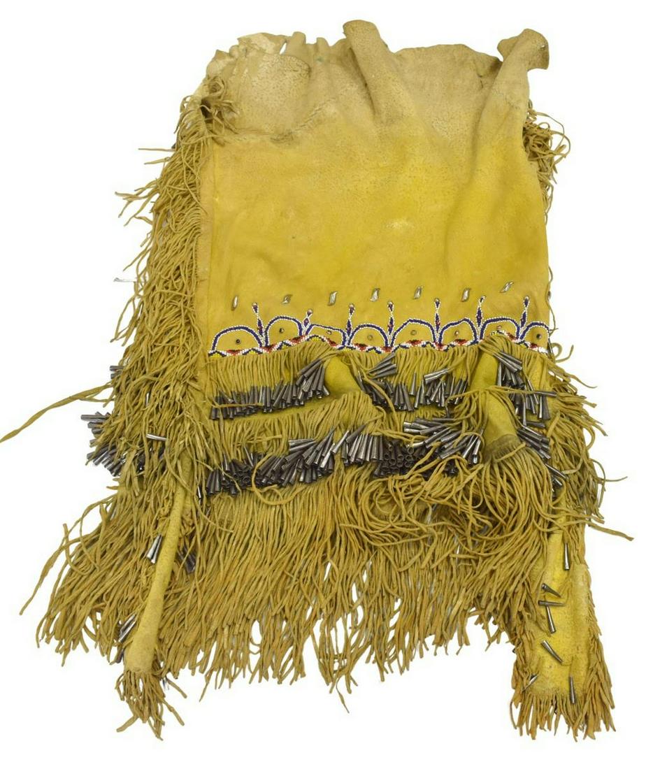 APACHE BEADED & DYED HIDE SKIRT, C.1925-1945: Native American beaded hide skirt, Apache, c.1925-1945, dyed yellow, two layers of fringe with tin cones, waist to bottom of fringe: approx 31"l, width: approx 18"w (excluding fringe), 4lbs Start Pric