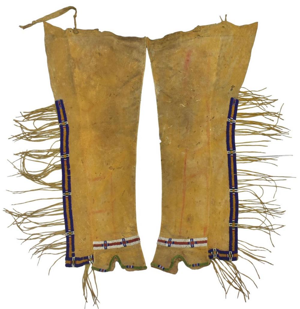 CHEYENNE OR ARAPAHO BEADED HIDE LEGGINGS, C.1900: Native American beaded hide leggings, Cheyenne or Arapaho, c.1880-1900, long fringe, applied yellow and red pigments, shaped area over feet, well used, some moth holes, approx 34"l, 14.5"w, 1.75lbs St