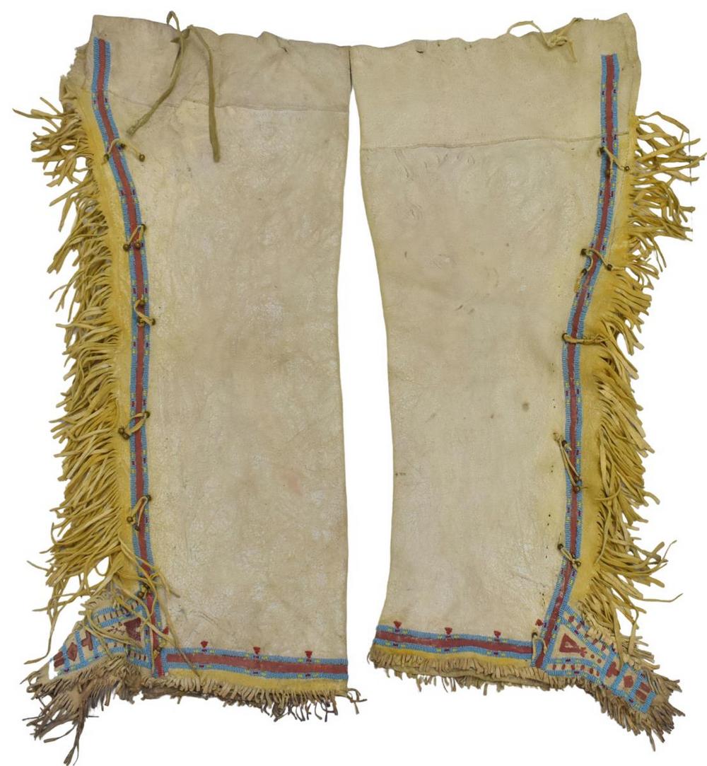 KIOWA BEADED & PAINTED HIDE LEGGINGS, C.1910-1925: Native American beaded hide leggings, Kiowa, c.1910-1925, deer hide, brass buttons, painted details and fringe, approx 34"l, 13"w, 2.25lbs Start Price: $300.00