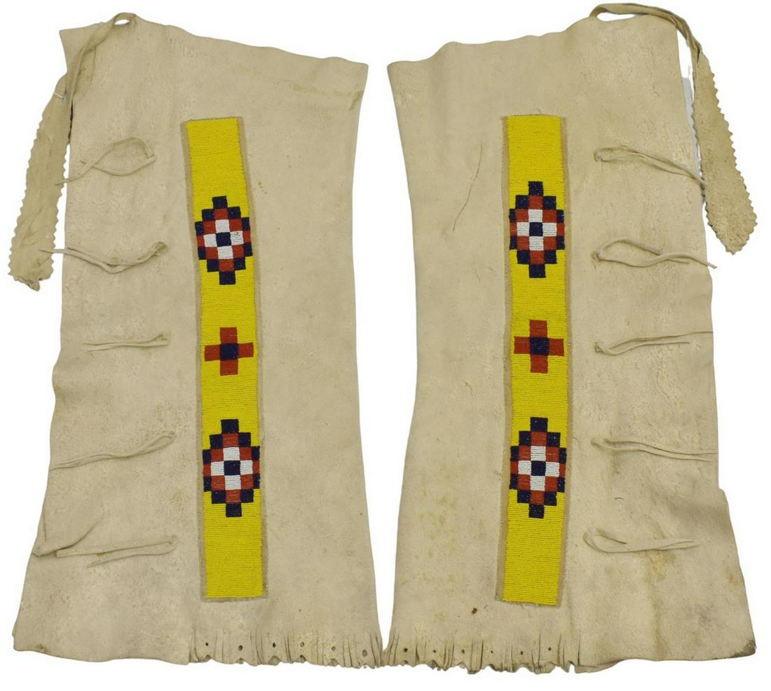 BLACKFOOT BEADED HIDE LEGGINGS, C.1930-1950: Native American beaded hide leggings, Blackfoot, c.1930-1950, short fringe, approx 33"l, 18.5"w, 3.75lbs Start Price: $80.00