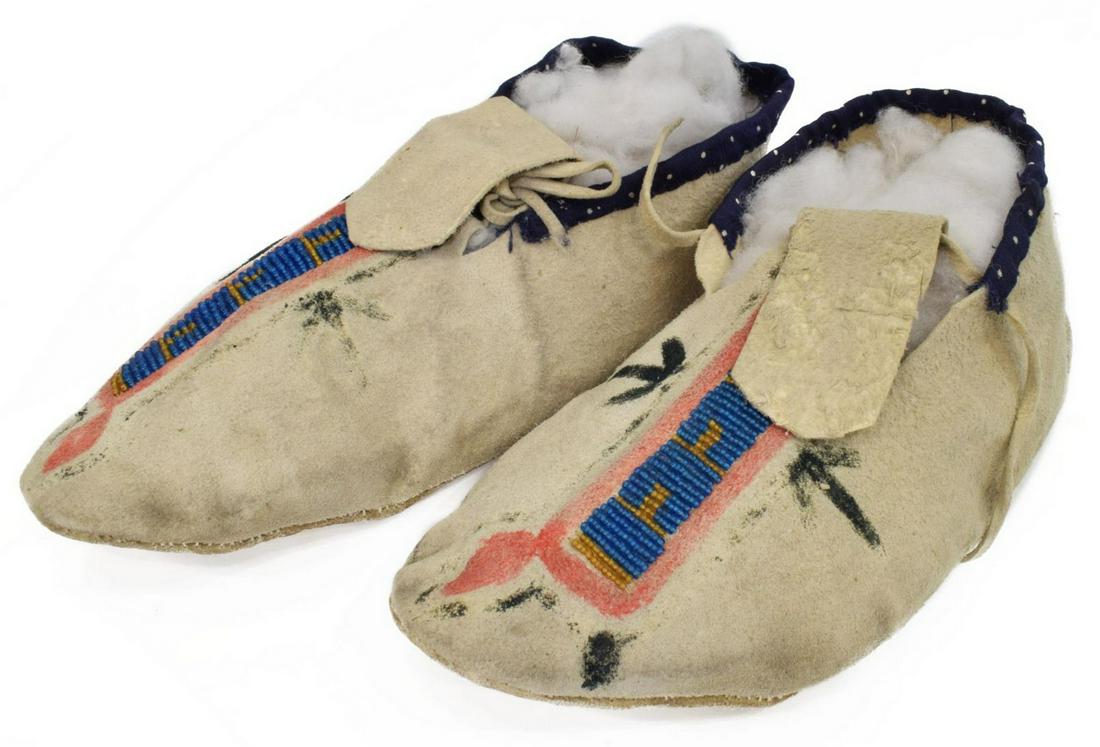 NORTHERN PLAINS BEADED HIDE MOCCASINS: Native American beaded hide moccasins, Northern Plains, each with beaded accents, fabric ankle lining, various worn painted symbols including arrows, added later, one pencil marked 8 underfoot, approx