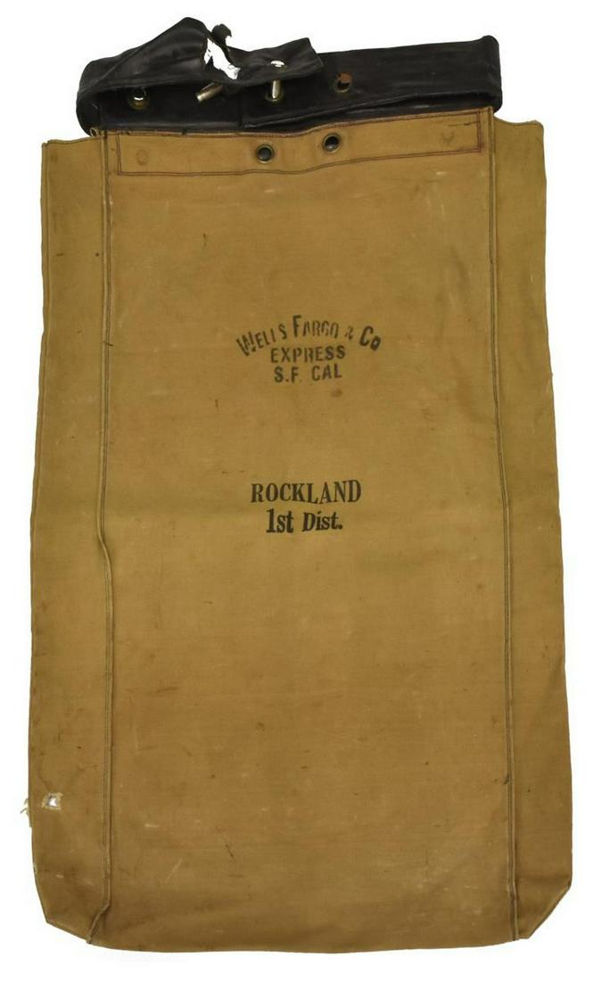 WELLS FARGO & CO. EXPRESS COLLECTION BAG: Wells Fargo collection bag, marked "Wells Fargo & Co., Express S.F. Cal., Rockland, 1st Dist.," top leather band with cylindrical steel lock bars, canvas, tears in canvas and leather, approx 30"h, 18"