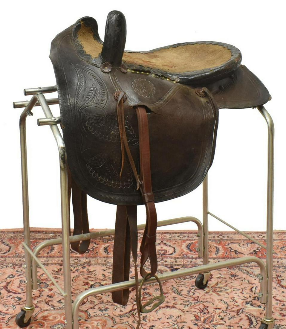 TEXAS TOOLED LEATHER SIDE SADDLE: Texas tooled leather side saddle, late 19th c., the cinch straps marked E. Heinrich, Mason, Texas, stamped number 521 **Provenance: Estate of Anna Mebus Martin (1843-1925), inductee into the National 
