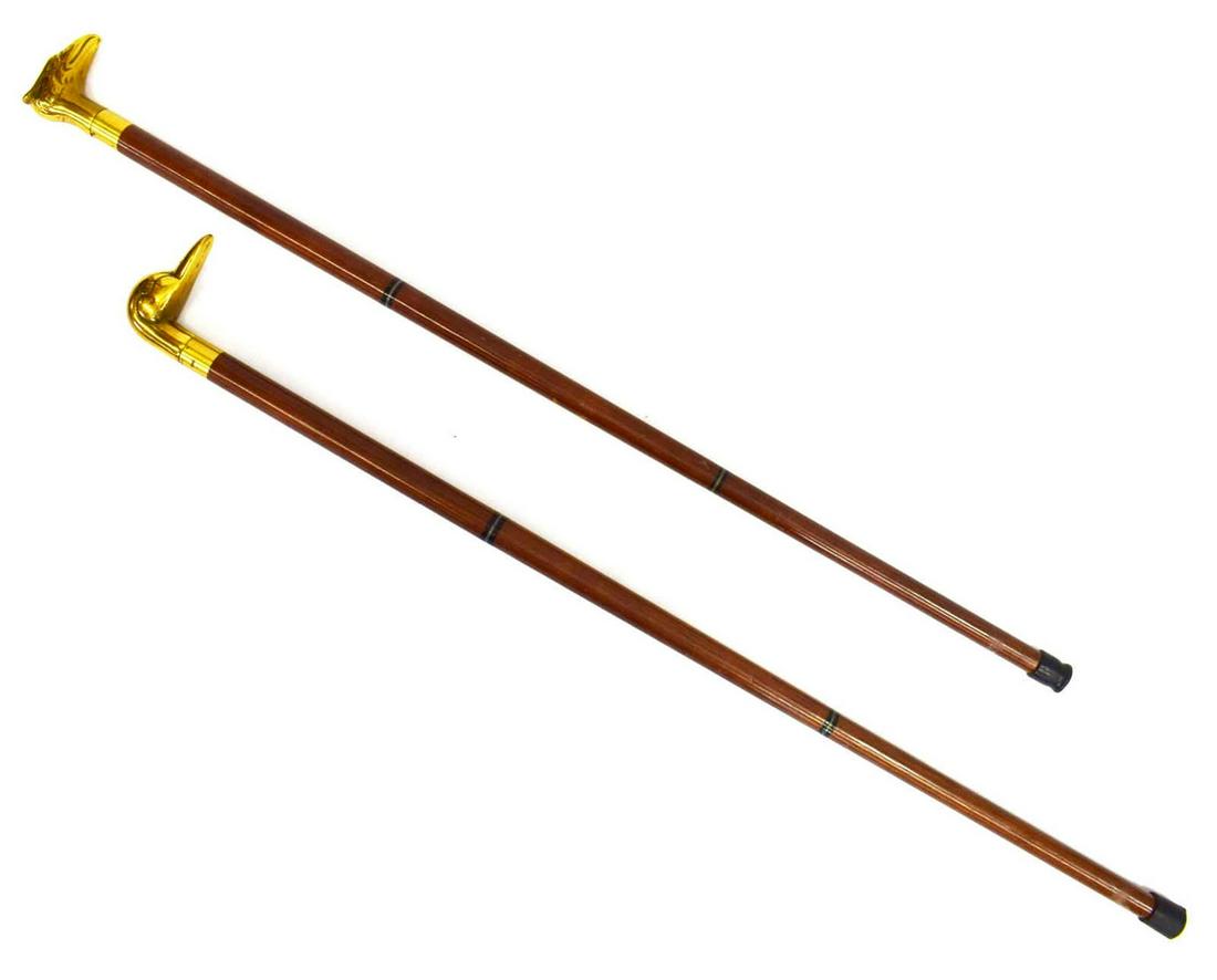 (2) VINTAGE BRASS BIRD HEAD WALKING STICKS CANES: (lot of 2) Vintage walking sticks, 20th c., each with concealed flask in brass handle, (1) with mallard duck head, (1) with eagle head, largest: approx 35"l Start Price: $100.00