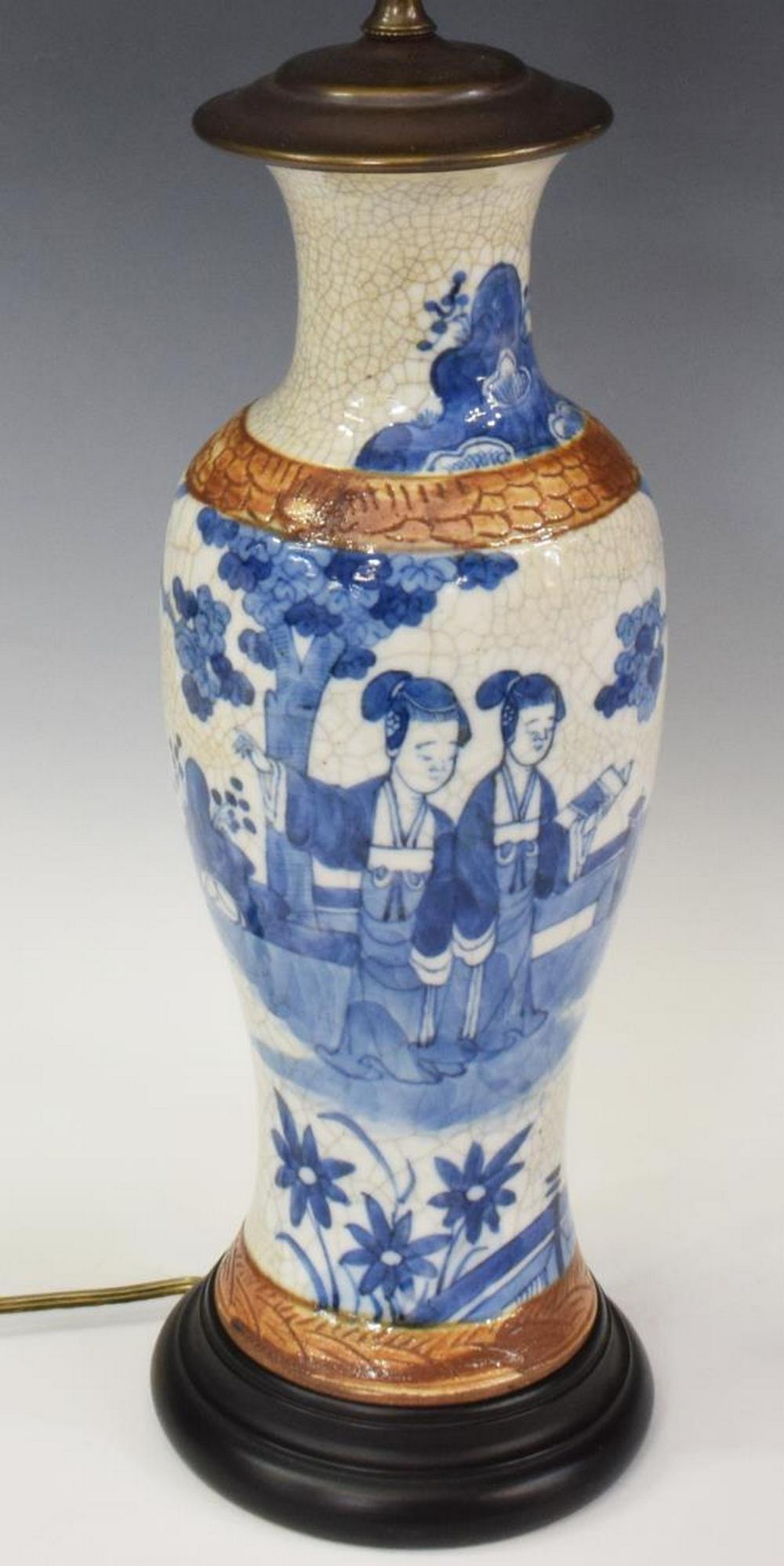 CHINESE BLUE & WHITE PORCELAIN VASE TABLE LAMP: Chinese blue and white porcelain vase, now fashioned as a table lamp, with figures in a landscape, crackle glaze, on an ebonized wood base, approx 19.25"h (to top of socket), overall: approx 29.75"h, 