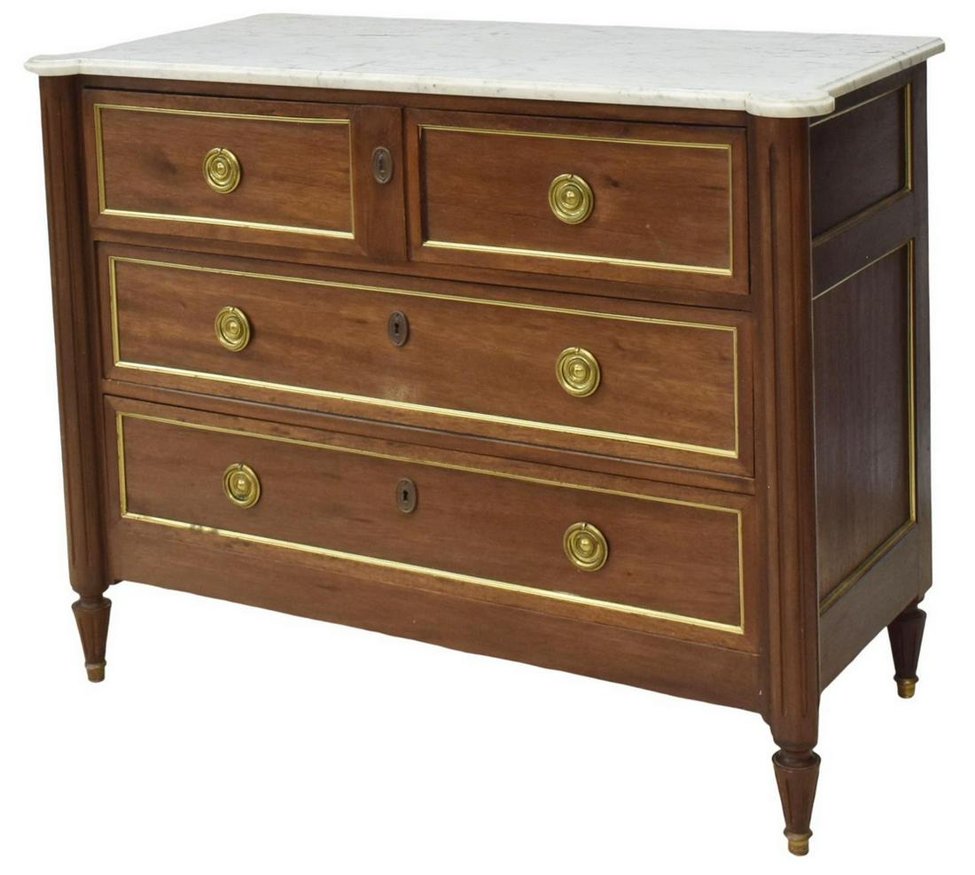 LOUIS XVI STYLE MARBLE-TOP MAHOGANY COMMODE: French Louis XVI style mahogany commode, early 20th c., having a marble top with protruding front corners over ribbed columns descending to flank three drawers, rising on tapered legs, approx 36"h, 46