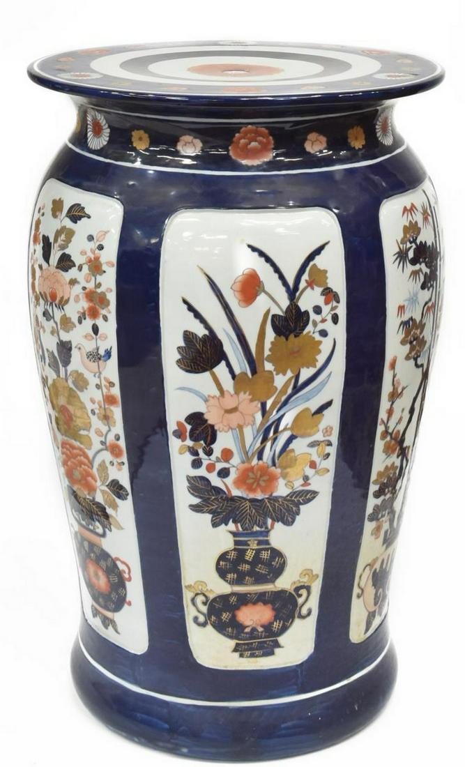 JAPANESE IMARI PALETTE PORCELAIN GARDEN STOOL: Japanese porcelain garden stool, in the Imari palette, having circular seat, over tapered vasiform body, reserves featuring bamboo, birds, and floral arrangements, approx 20.25"h, 13.5"diam, 24.25lbs 
