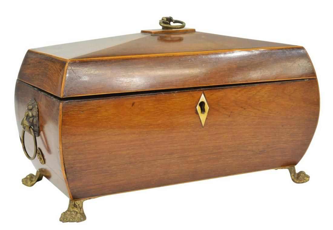 ENGLISH REGENCY MAHOGANY FITTED TEA CADDY: English Regency mahogany tea caddy, early 19th c., sarcophagus-form box, with bone escutcheon, lion mask and ring handles, interior fitted with two removable boxes, cut-crystal tumbler, rising on paw 