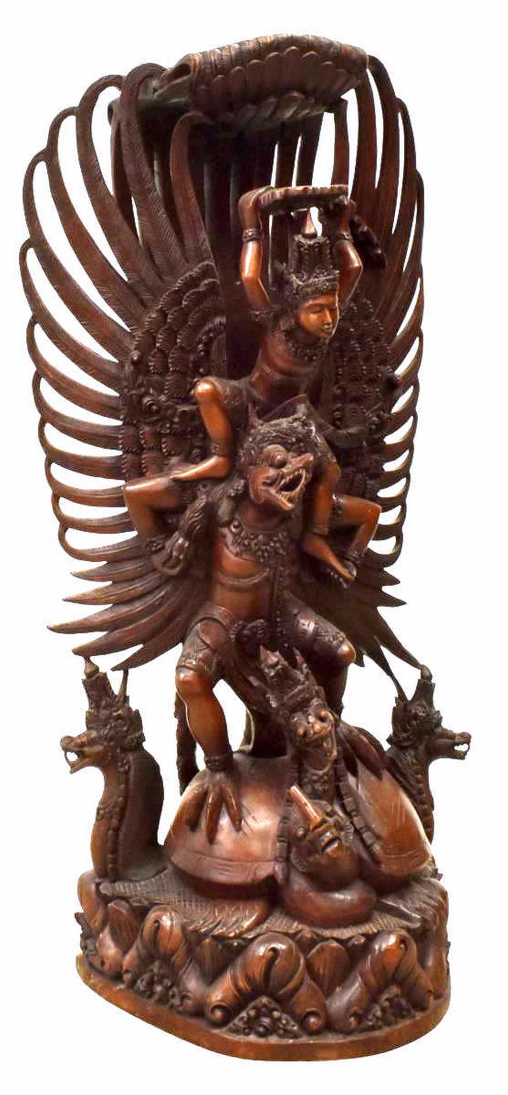 LARGE BALINESE CARVED VISHNU & GARUDA FIGURE GROUP: Large Balinese carved hardwood figure group, Vishnu and Garuda, Vishnu shielded by a canopy of feathers, astride Garuda, base with tortoise and nagas, approx 41"h **Provenance: From the estate of Ali 