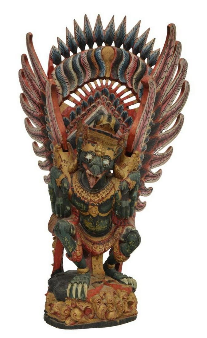 LARGE BALINESE CARVED & PAINTED FIGURE OF GARUDA: Large Balinese carved wood figure of Garuda, parcel gilt and polychrome painted, split in base, approx 25.5"h, 15.5"w, 9lbs Start Price: $50.00