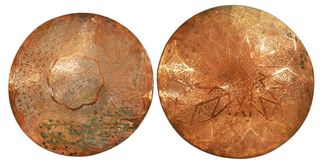 2) ISLAMIC ARABESQUE CALLIGRAPHIC COPPER CHARGERS: (lot of 2) Islamic copper wall chargers, each of varied design, decorated with arabesques and calligraphic motifs, spotted patination to both, approx 16.75"diam; 6.25lbs total **Provenance: From the e