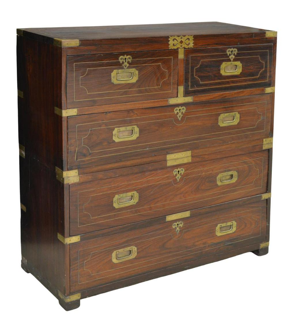 BRITISH COLONIAL ROSEWOOD CAMPAIGN CHEST DRAWERS: British Colonial rosewood campaign chest of drawers, 20th c., in two parts, rectangular case fitted with brass string inlay, corner mounts and scrolled accents, housing five drawers, with campaign han