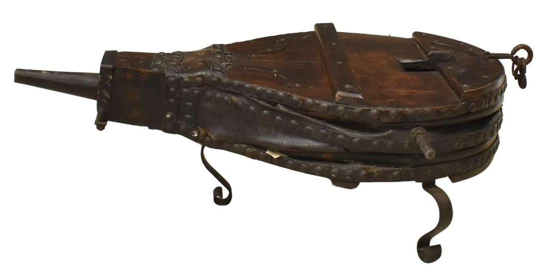 ANTIQUE FRENCH BLACKSMITH'S BELLOW COFFEE TABLE: Large antique blacksmith's bellows, 19th c., now fashioned as a coffee table, oak and leather bellow, visible nailheads, mounted on wrought iron legs, approx 19"h, 60"w, 33"d Start Price: $150.00