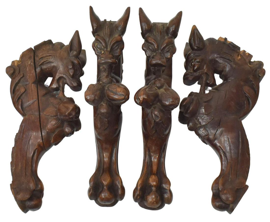 (4) CONTINENTAL FIGURAL CARVED OAK ARCHITECTURALS: (lot of 4) Continental figural carved oak architectural elements, 19th c., each demi-figure as a paw foot griffin with open mouth, issuing a fruited pendant, approx 15.5"l, 4"w, 8.5"d; 16.5lbs total *